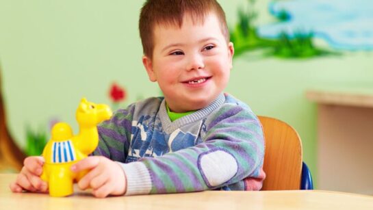 Smiling boy with a toy