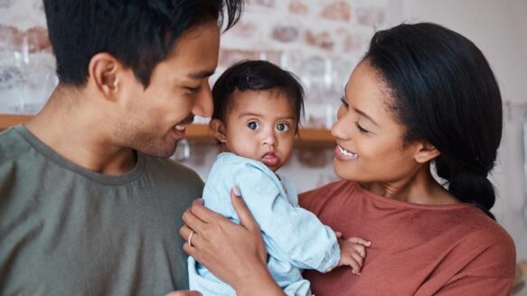 happy parents and baby with down syndrome